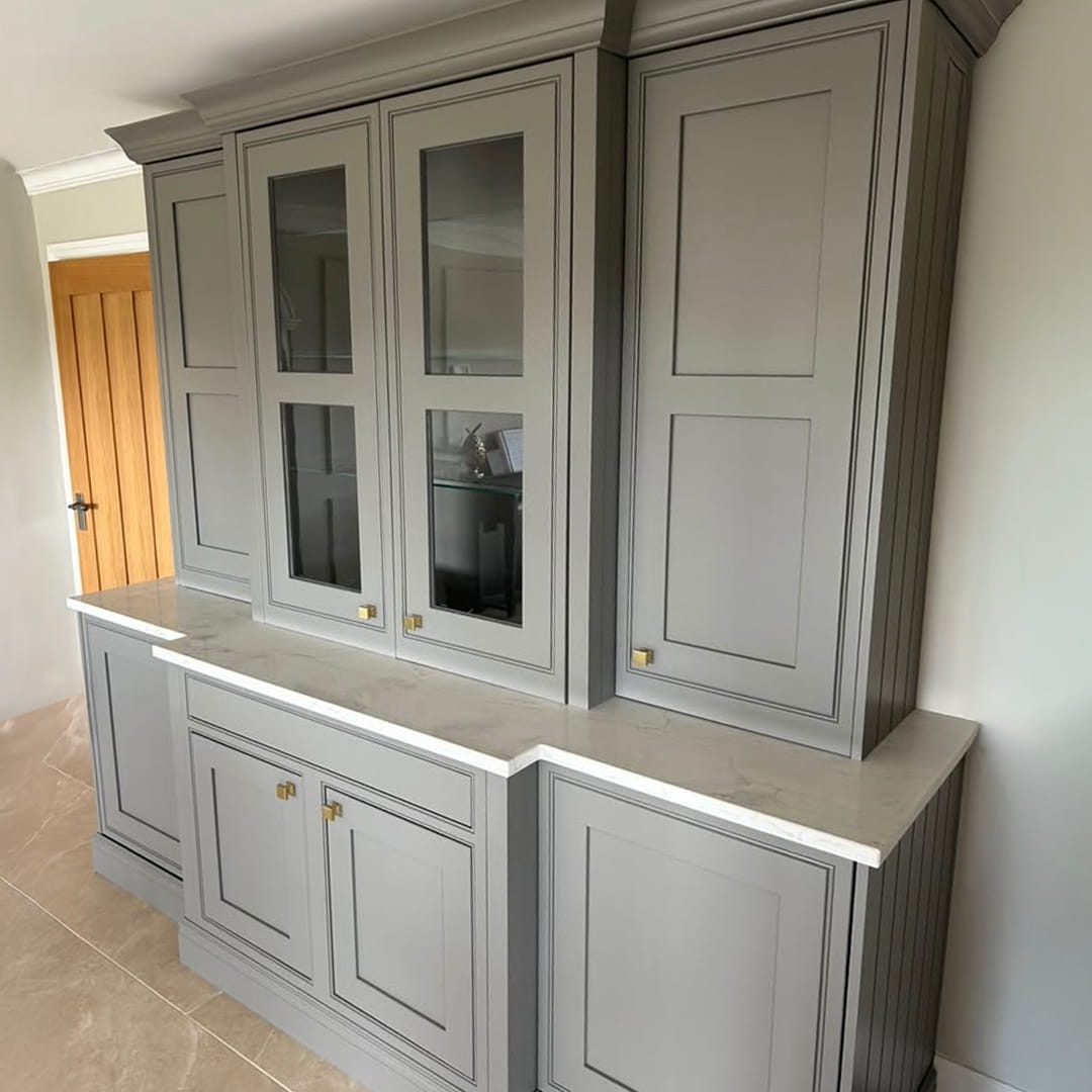 From a standard fitted unit to a fully bespoke feature piece. This project was completely reworked by Creative Finish Carpentry — introducing pocket doors, bespoke glass panel sections, and refined proportions to elevate both function and design. Once the structure was perfected, the entire unit was professionally sprayed in Farrow & Ball “Moles Breath 276” using our factory-grade 2K system. The result is a seamless, durable finish with depth, richness, and a true furniture-quality look — built to last and designed to stand out.