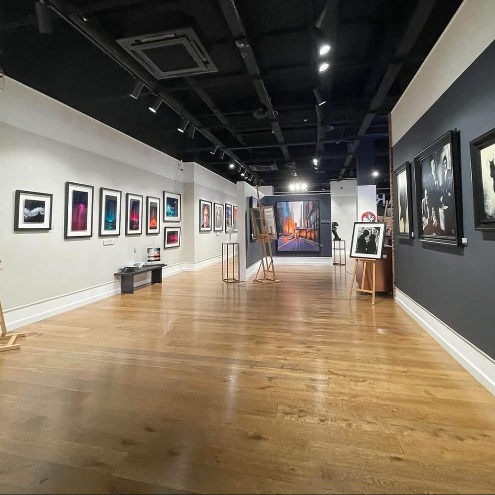The inside of an art gallery that has been painted by hand on the walls and woodwork
